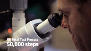 A man looking into microscope, with texts located on the bottom left corner reading as “HP Total Test Process” and “50,000 steps”   